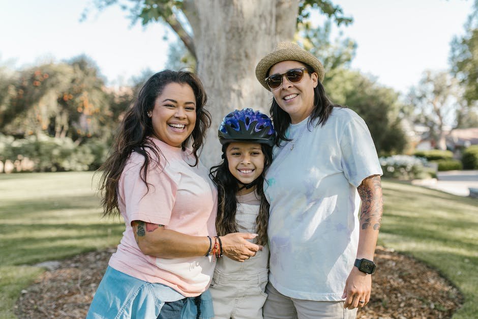 A diverse family sitting together, smiling and enjoying their time together.