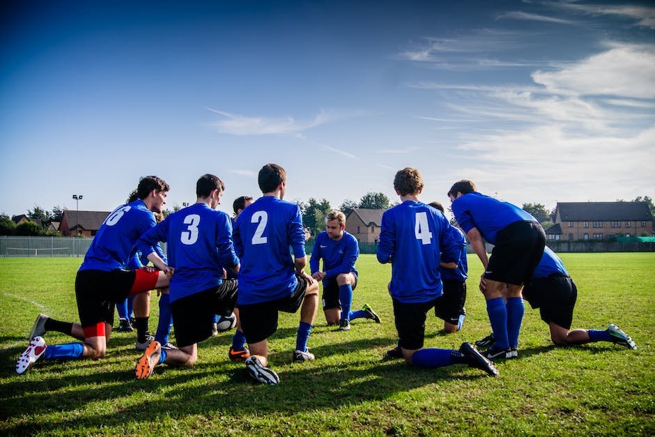A diverse group of athletes, both male and female, competing together on a sports field.